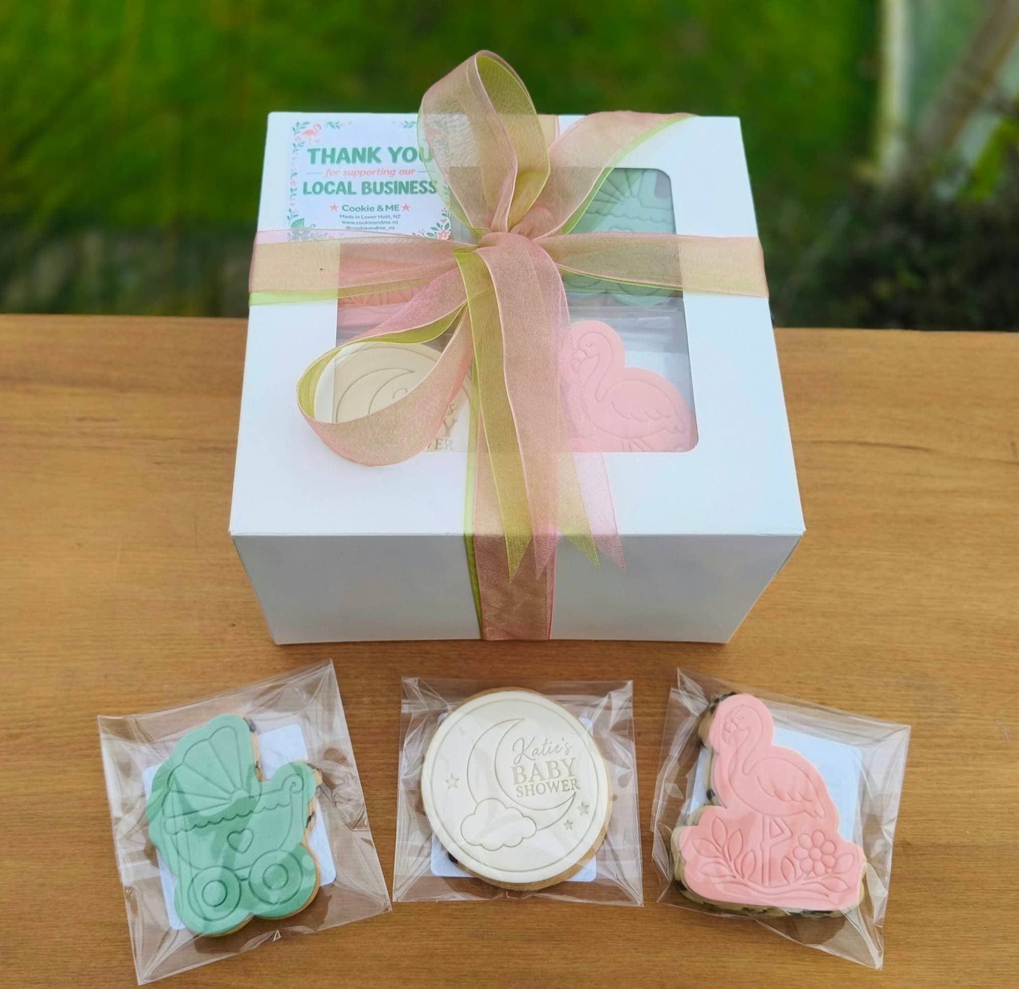 Baby shower gift box with flamingo, pram, and moon cookies