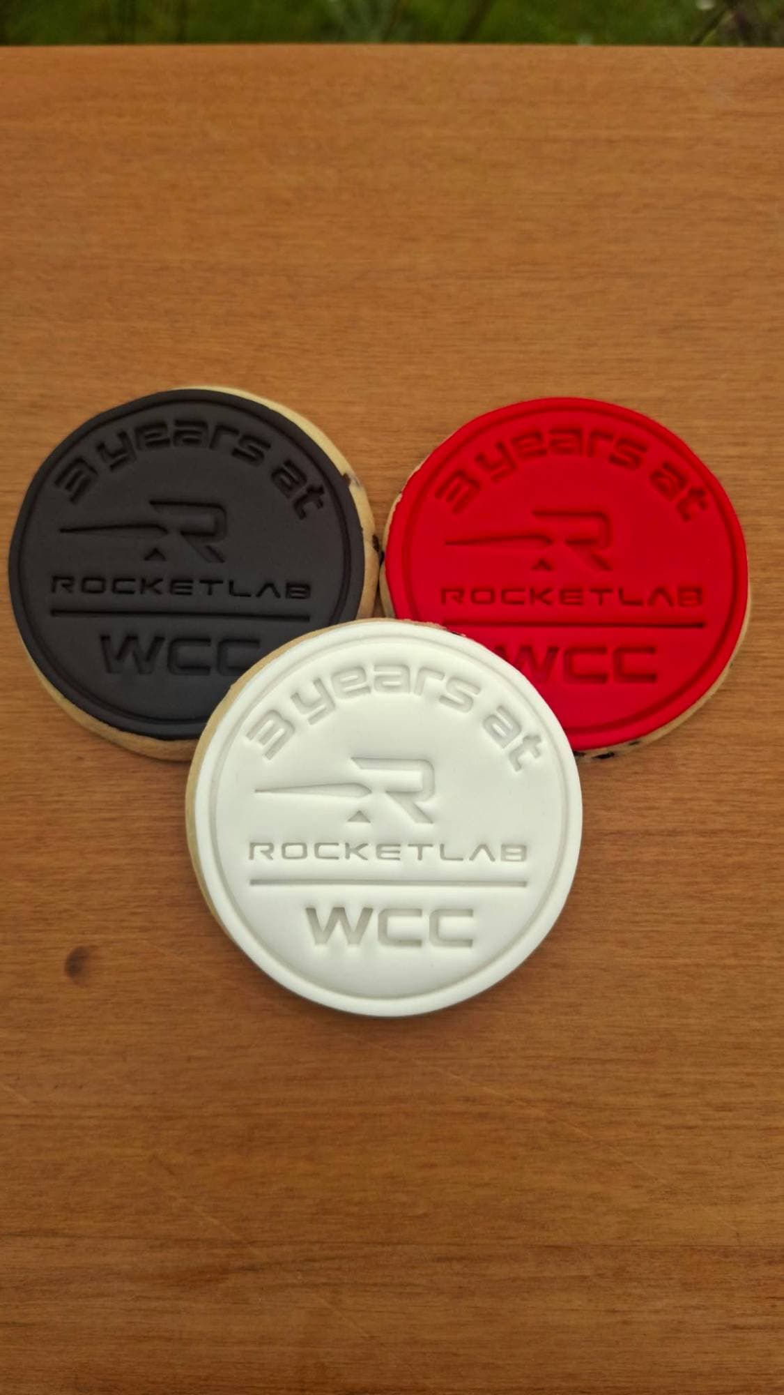 Rocket Lab "3 years at WCC" cookies in black, red, and white