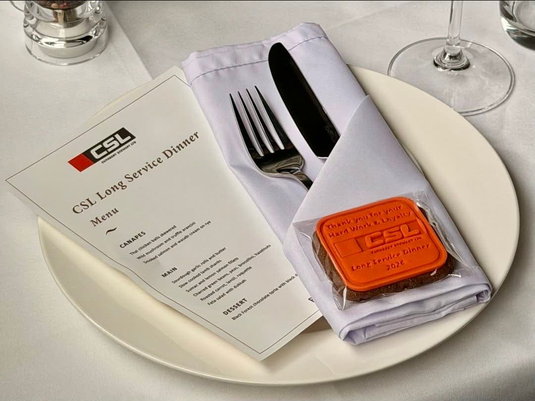 CSL branded cookie at a Long Service Dinner place setting
